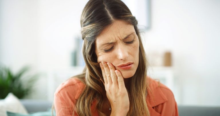 Woman, sore mouth and toothache at house from dental cavity