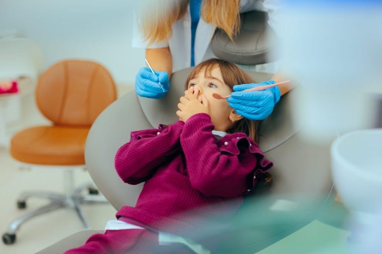 Scared Anxious Little Girl Feeling Afraid of the Dentist. Terrified child of the medical procedures in a dental clinic