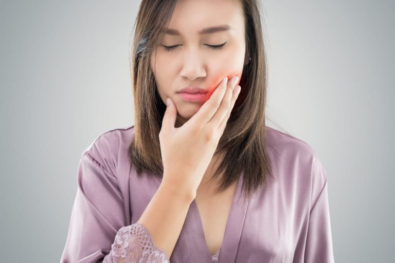 Suffering from toothache. Beautiful young woman suffering from toothache