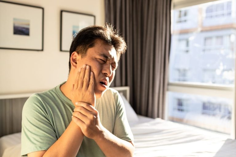 Middle aged man suffer Trigeminal neuralgia, touch his cheek with hand, severe pain of a nerve in face