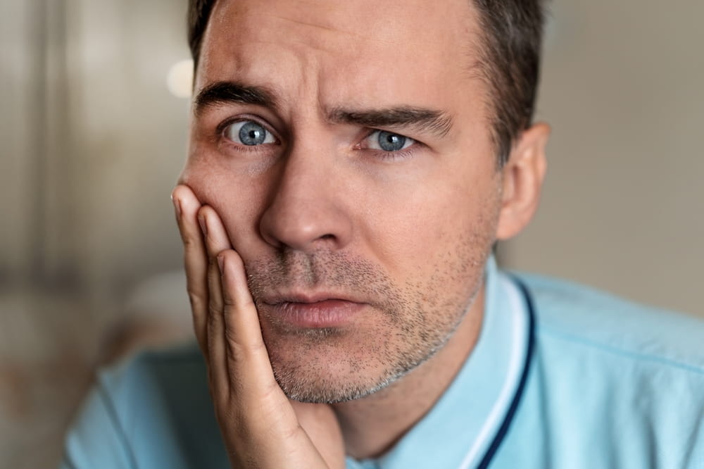Portrait of a man in painful expression with a toothache